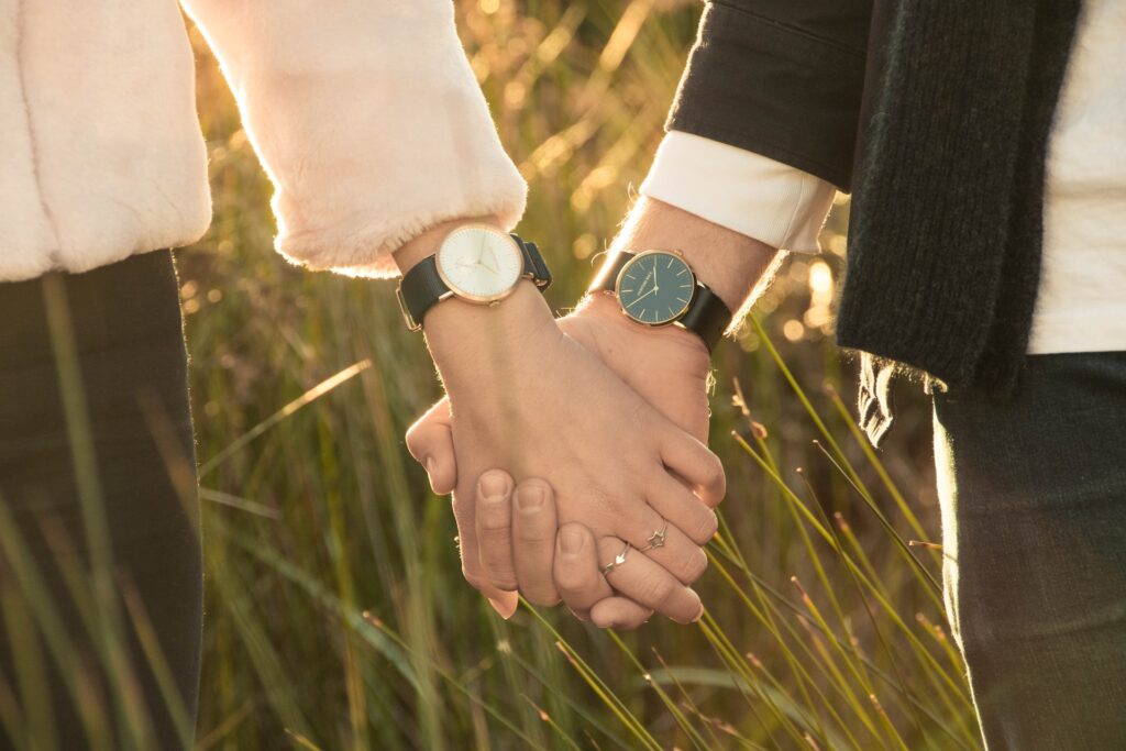 Man and woman holding hands.